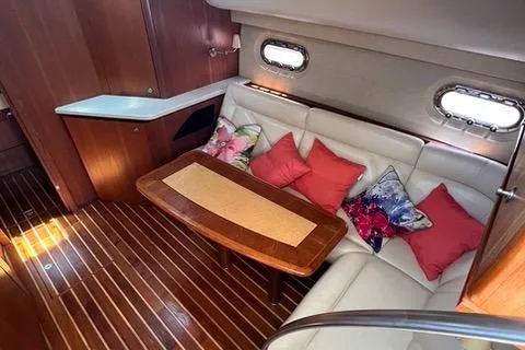 Slide: The Image of Interior of 2007 Tiara Yachts 4300 Sovran with cozy seating and colorful cushions. - 18