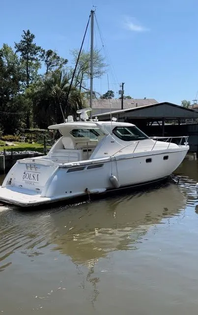 Slide: The Image of 2007 Tiara Yachts 4300 Sovran in a serene marina setting. - 2