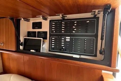 Slide: The Image of Control panel of 2007 Tiara Yachts 4300 Sovran, featuring electronic systems and wooden cabinetry. - 21