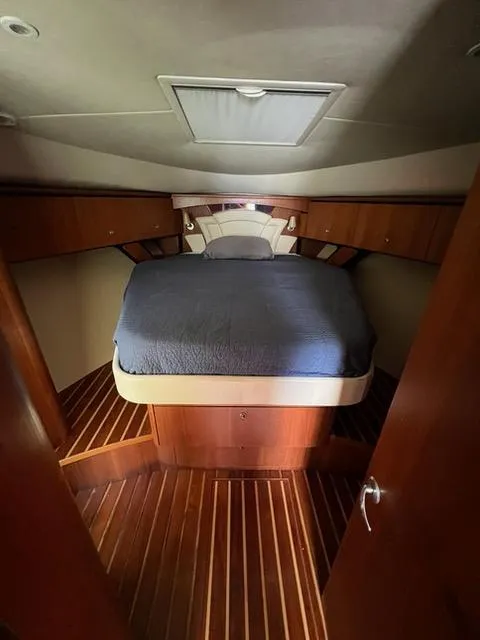 Slide: The Image of 2007 Tiara Yachts 4300 Sovran cabin with wooden interior and cozy bed. - 24