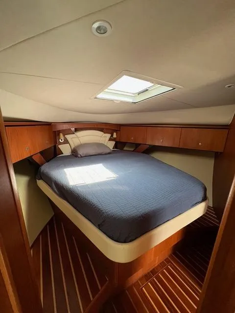 Slide: The Image of Luxurious cabin interior of 2007 Tiara Yachts 4300 Sovran with cozy bed and wooden accents. - 25
