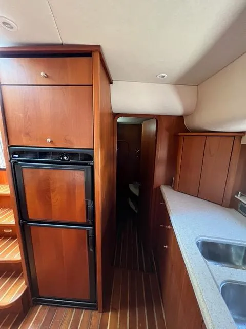 Slide: The Image of Interior of 2007 Tiara Yachts 4300 Sovran with wood cabinetry and modern kitchen. - 34
