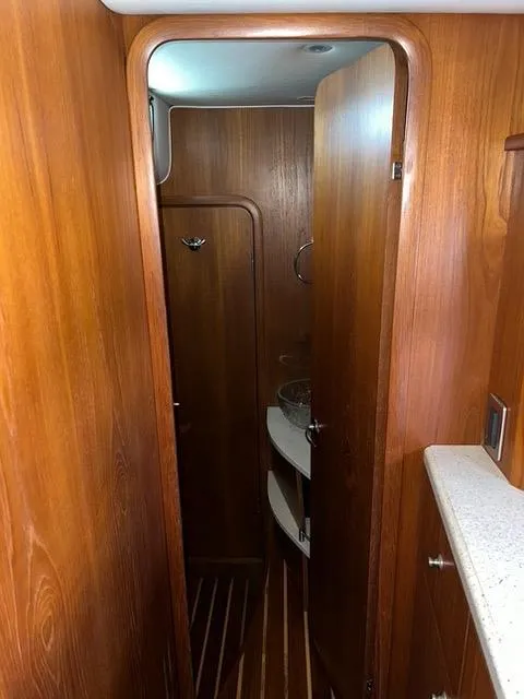 Slide: The Image of Interior of 2007 Tiara Yachts 4300 Sovran with wooden cabinetry and compact bathroom. - 36