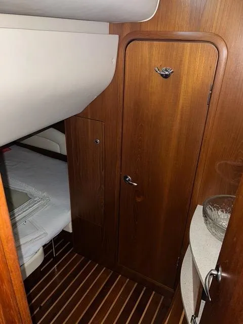 Slide: The Image of 2007 Tiara Yachts 4300 Sovran cabin interior with wooden door and flooring. - 37