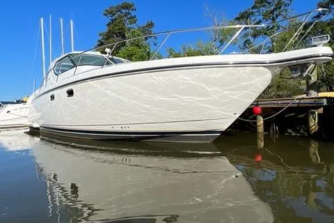 Slide: The Image of 2007 Tiara Yachts 4300 Sovran docked on calm water, clear blue sky. - 4