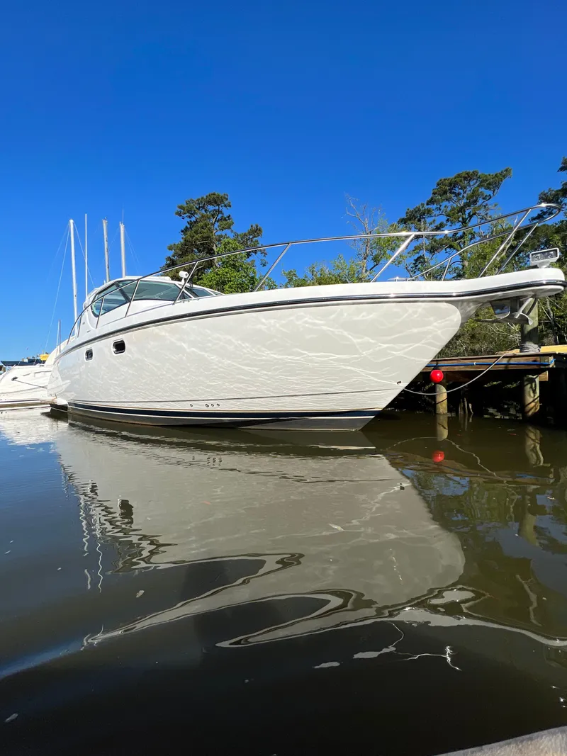 Slide: The Image of 2007 Tiara Yachts 4300 Sovran docked on calm water under clear blue sky. - 47