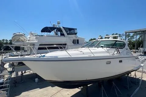 Slide: The Image of 2007 Tiara Yachts 4300 Sovran docked under clear blue sky. - 6