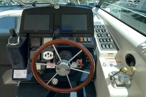 Slide: The Image of 2007 Tiara Yachts 4300 Sovran helm with dual screens and wooden steering wheel. - 8