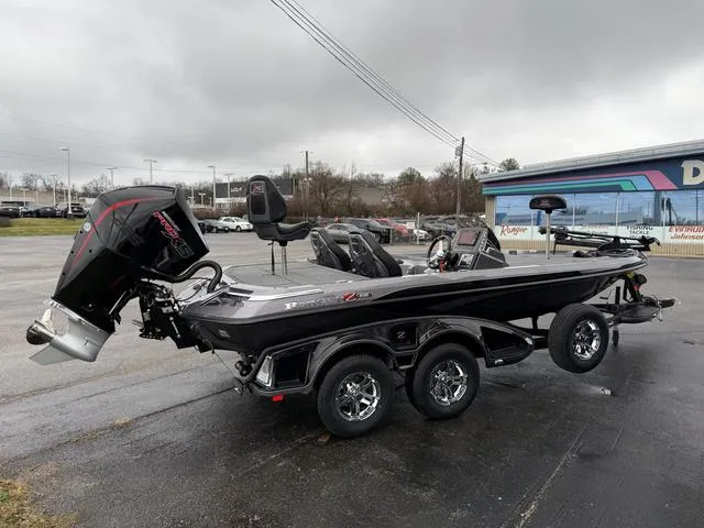 Slide: The Image of 2025 Ranger Z519R bass boat with dual axle trailer, parked outdoors on a cloudy day. - 5