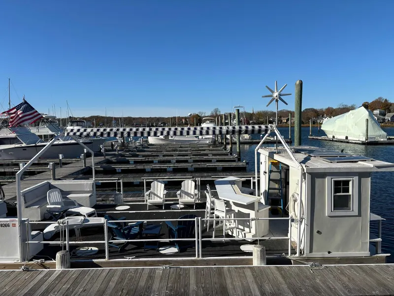 Slide: The Image of Custom MKI Pontoon Boat 2022 docked at marina under clear blue sky. - 2