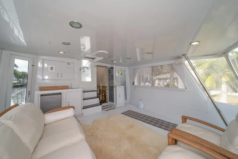 Slide: The Image of Luxurious interior of 1999 Hatteras 52 Cockpit Motor Yacht with plush seating and modern amenities. - 22