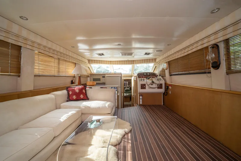 Slide: The Image of Interior of 1999 Hatteras 52 Cockpit Motor Yacht with elegant seating and helm station. - 26