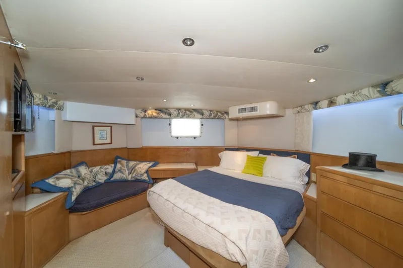 Slide: The Image of Luxurious bedroom interior of 1999 Hatteras 52 Cockpit Motor Yacht with cozy bed and seating. - 34