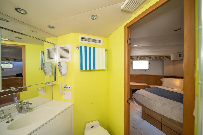 Slide: The Image of Bathroom and bedroom interior of 1999 Hatteras 52 Cockpit Motor Yacht. - 38