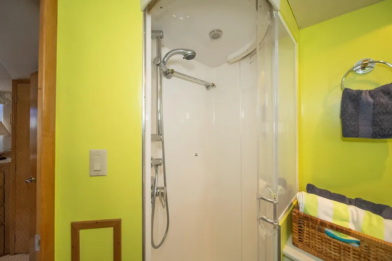 Slide: The Image of Shower area in 1999 Hatteras 52 Cockpit Motor Yacht with bright yellow walls. - 40