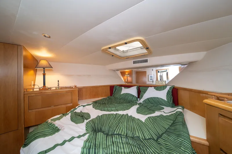 Slide: The Image of Cozy bedroom in 1999 Hatteras 52 Cockpit Motor Yacht with skylight and green bedding. - 41