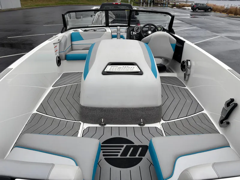 Slide: The Image of 2017 Malibu Response TXi Open Bow boat interior with gray and blue seating. - 3