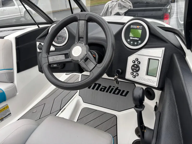 Slide: The Image of 2017 Malibu Response TXi Open Bow boat dashboard with steering wheel and controls. - 4