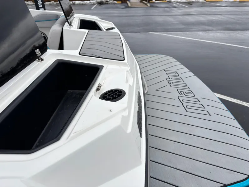 Slide: The Image of 2017 Malibu Response TXi Open Bow boat, rear deck view with storage compartments. - 5