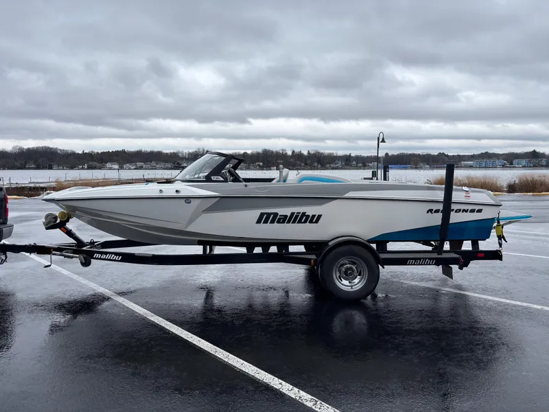Slide: The Image of 2017 Malibu Response TXi Open Bow boat on trailer in parking lot. - 7