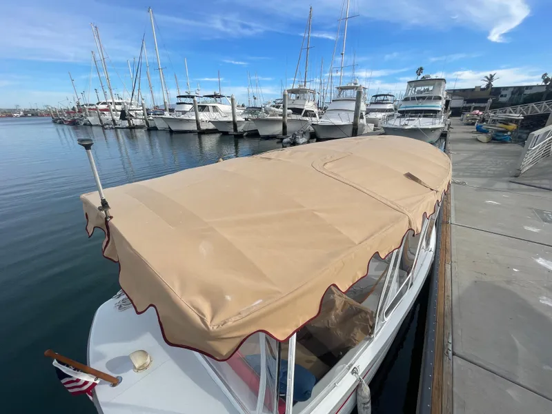 Slide: The Image of 2018 Duffy Bay Island 22 docked at marina with beige canopy. - 11