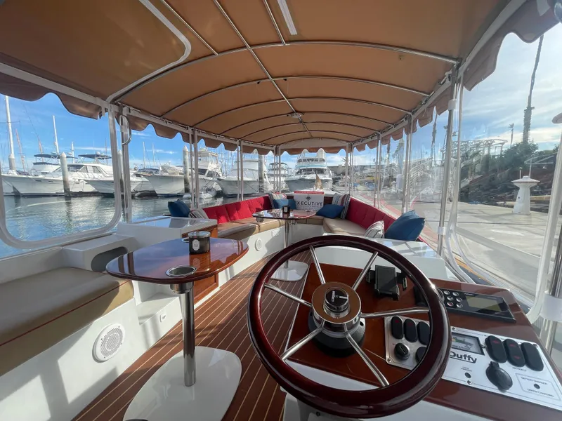 Slide: The Image of Interior of 2018 Duffy Bay Island 22 boat with elegant seating and steering wheel. - 5