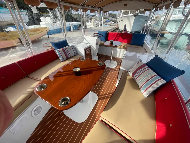 Slide: The Image of Luxurious 2018 Duffy Bay Island 22 boat interior with plush seating and elegant wood table. - 7