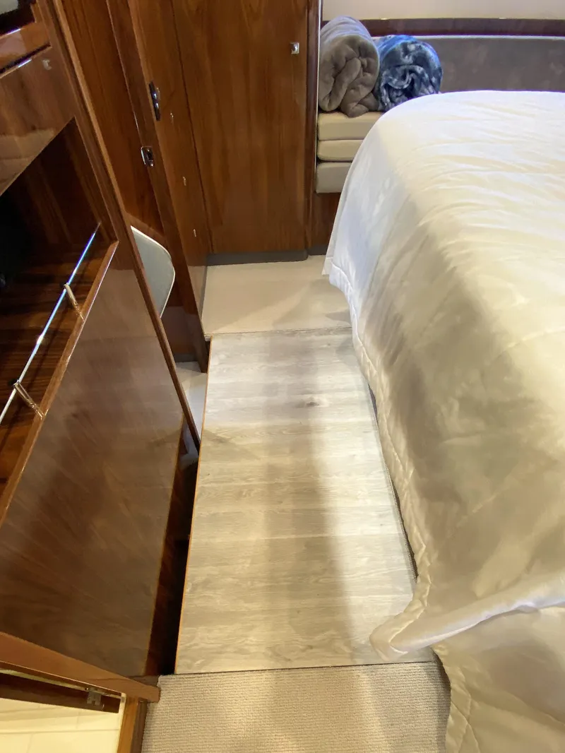 Slide: The Image of Luxurious bedroom interior of 2021 Riviera 5400 Sport Yacht with elegant wood finishes. - 40