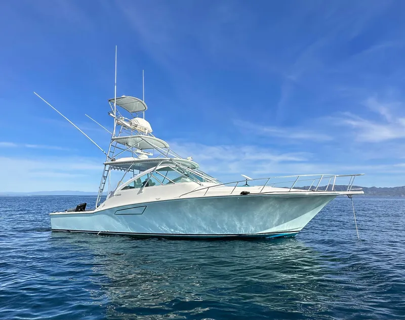 The Image of 2005 Cabo Express 40 yacht on calm blue ocean under clear sky. - 0