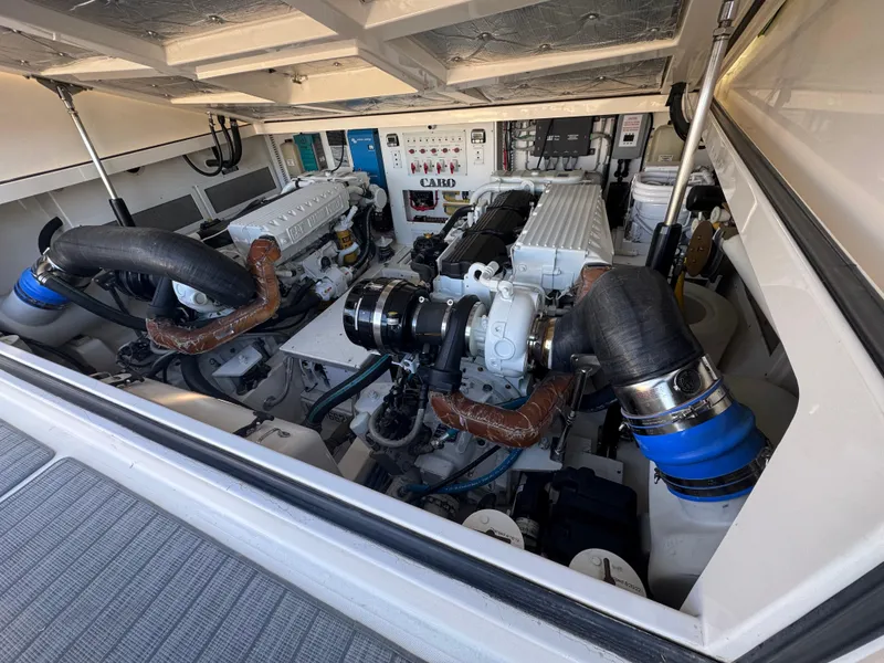 Slide: The Image of Engine room of a 2005 Cabo 40 Express boat, showcasing dual engines and mechanical components. - 11