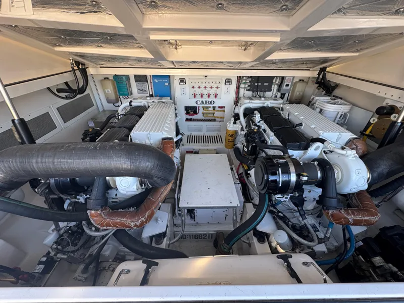 Slide: The Image of Engine room of 2005 Cabo 40 Express boat with dual engines and control panel. - 12