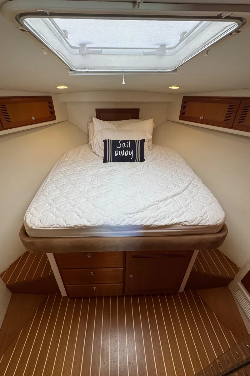 Slide: The Image of Cozy cabin interior of 2005 Cabo 40 Express with bed and skylight. - 16