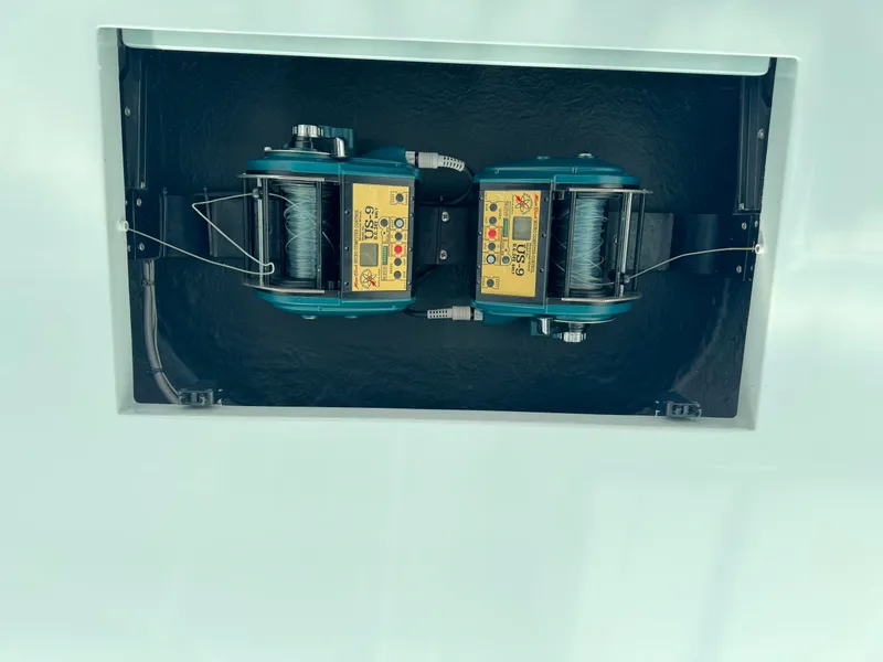 Slide: The Image of Dual electric fishing reels on a 2005 Cabo 40 Express boat. - 21