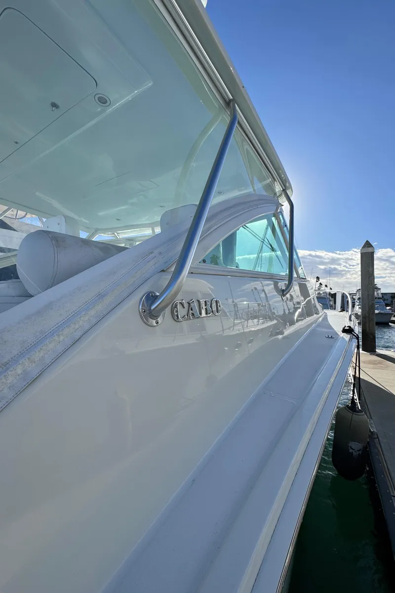 Slide: The Image of 2005 Cabo 40 Express yacht docked under clear blue sky. - 23
