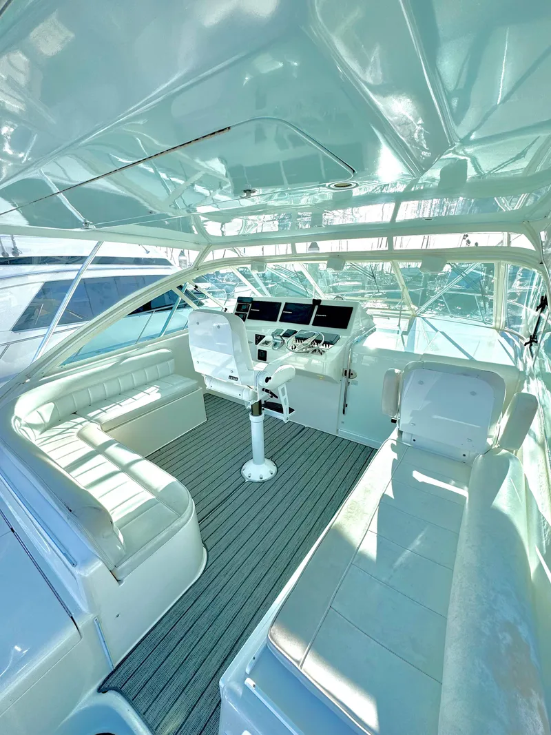 Slide: The Image of 2005 Cabo 40 Express yacht interior with helm and seating area. - 5