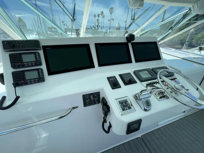 Slide: The Image of Helm of 2005 Cabo 40 Express yacht with modern navigation equipment and controls. - 6