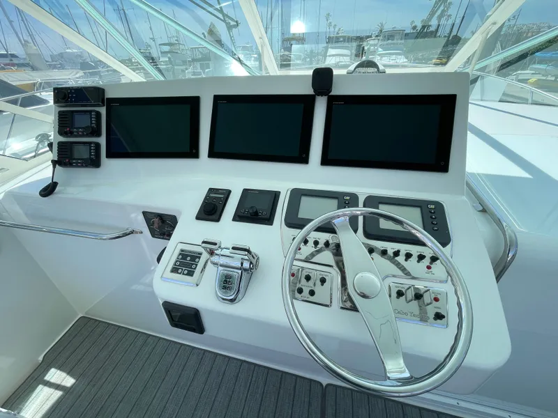 Slide: The Image of Helm of 2005 Cabo 40 Express boat with modern navigation displays and controls. - 7