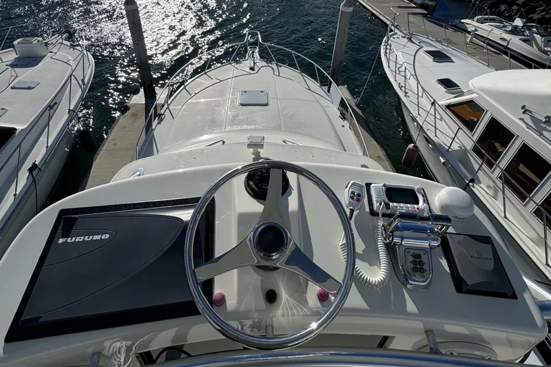 Slide: The Image of 2005 Cabo 40 Express yacht helm with steering wheel and navigation equipment. - 9