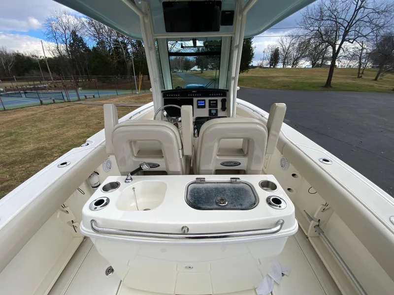 Slide: The Image of 2020 Boston Whaler 280 Outrage boat interior with helm and seating area. - 18