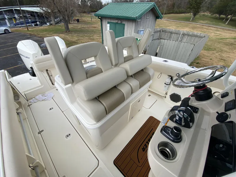 Slide: The Image of 2020 Boston Whaler 280 Outrage boat interior with helm and seating area. - 24