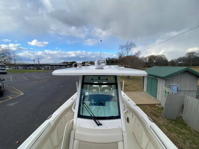 Slide: The Image of 2020 Boston Whaler 280 Outrage boat docked under cloudy sky. - 27