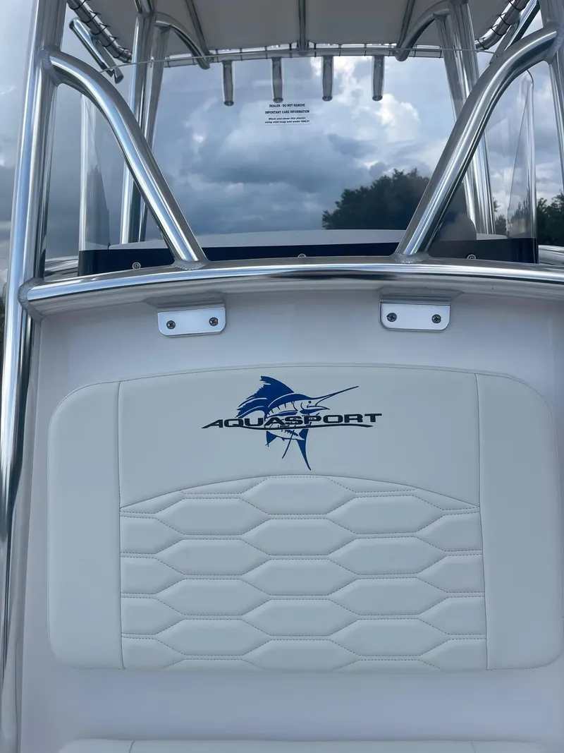 Slide: The Image of 2024 Aquasport 220 CC boat interior with logo and sleek design. - 17