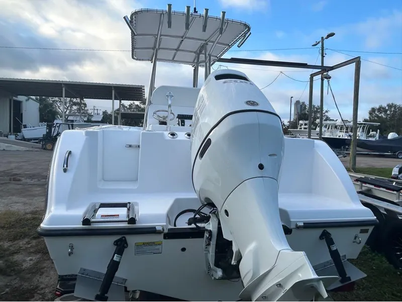 Slide: The Image of 2024 Aquasport 2200 CC boat with powerful outboard motor, docked outdoors. - 19