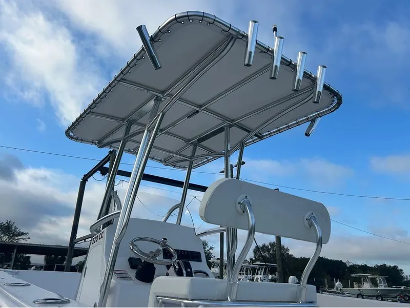 Slide: The Image of 2024 Aquasport 2200 CC boat with T-top under blue sky. - 20