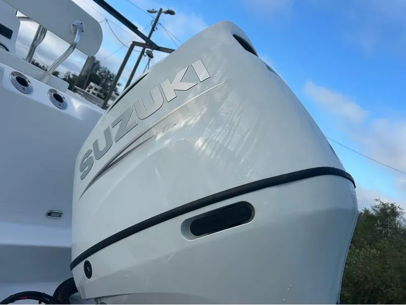 Slide: The Image of Suzuki outboard motor on 2024 Aquasport 2200 CC boat under blue sky. - 21