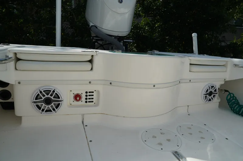 Slide: The Image of 2015 Everglades 243 CC boat interior with speakers and storage compartments. - 10