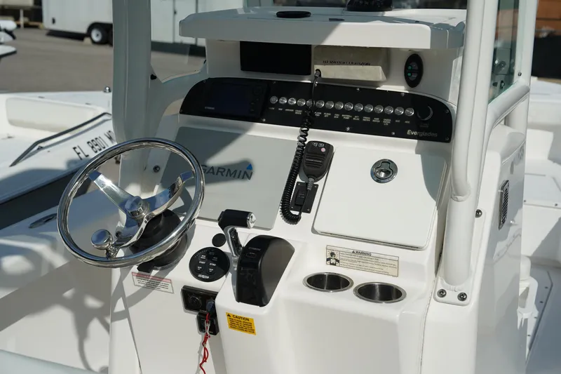 Slide: The Image of 2015 Everglades 243 CC boat console with steering wheel and navigation controls. - 11
