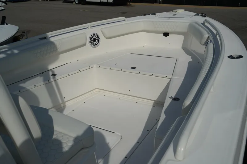 Slide: The Image of 2015 Everglades 243 CC boat interior with spacious seating and storage compartments. - 14
