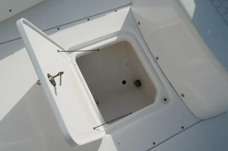 Slide: The Image of Open storage compartment on 2015 Everglades 243 CC boat deck. - 16