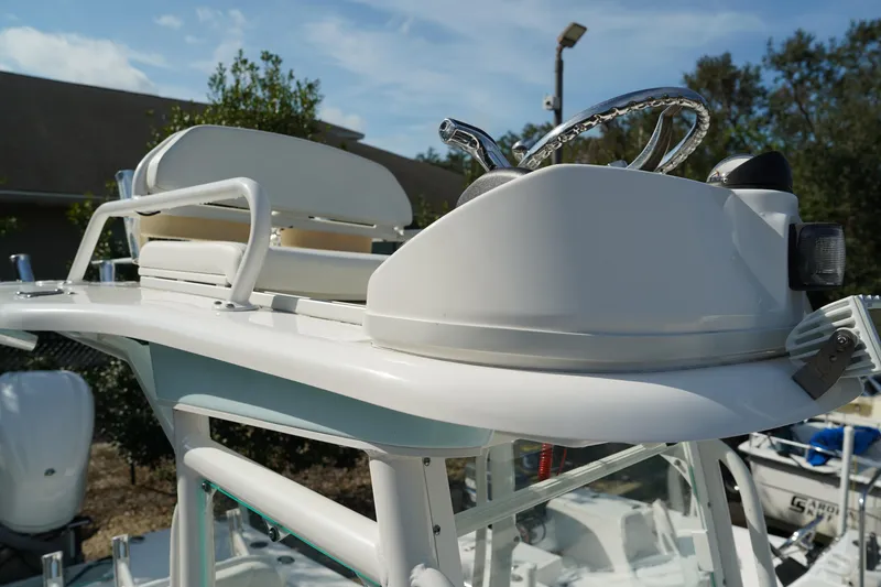 Slide: The Image of 2015 Everglades 243 CC boat helm with steering wheel and seating. - 19